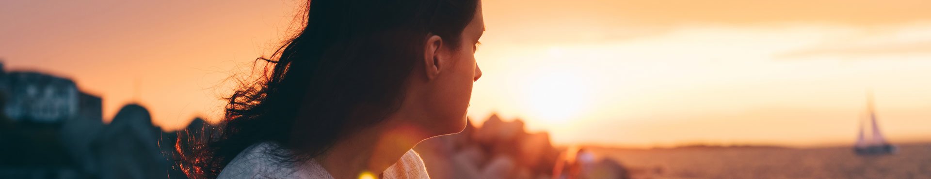 Female looking at a sunset | Shine Lawyers